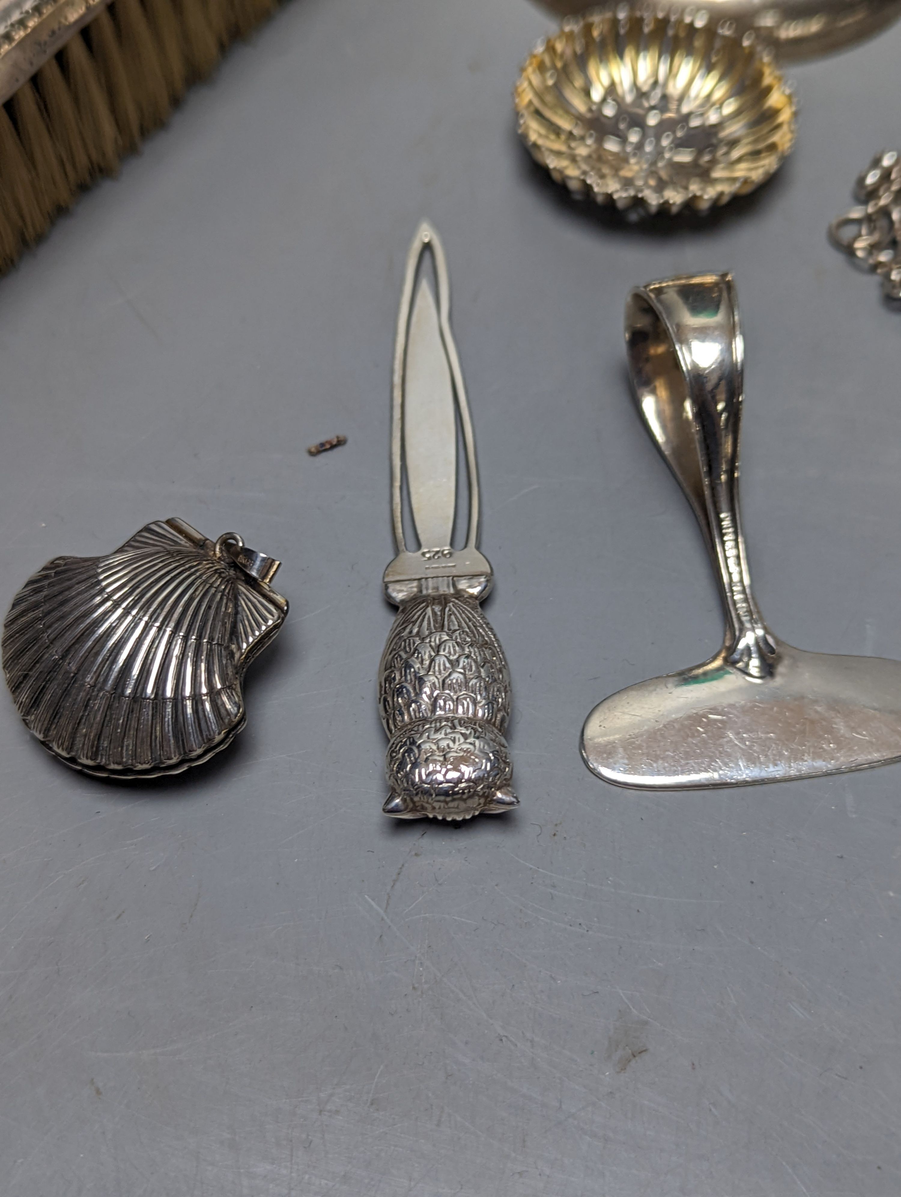 Mixed collectable small silver etc. including silver cream jug, clothes brush, mounted glass posy vase, sugar tongs, owl book mark, spoons and other items.